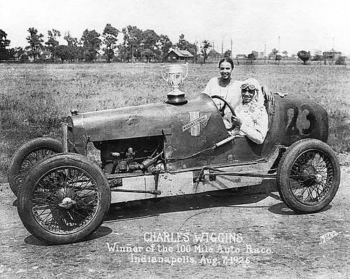 Charles Wiggins in his race car after winning the 100 Mile Auto Race in Indianapolis, 1926