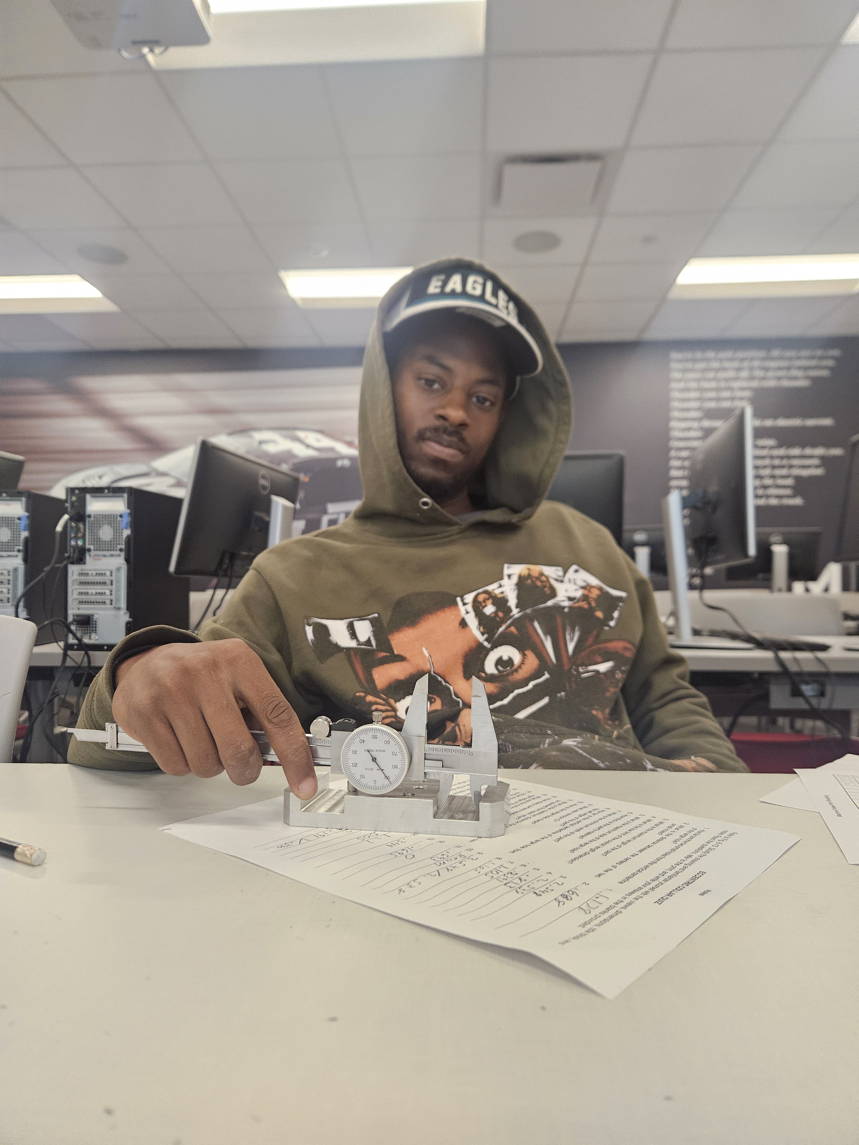 UYRS student measuring a machined part with calipers